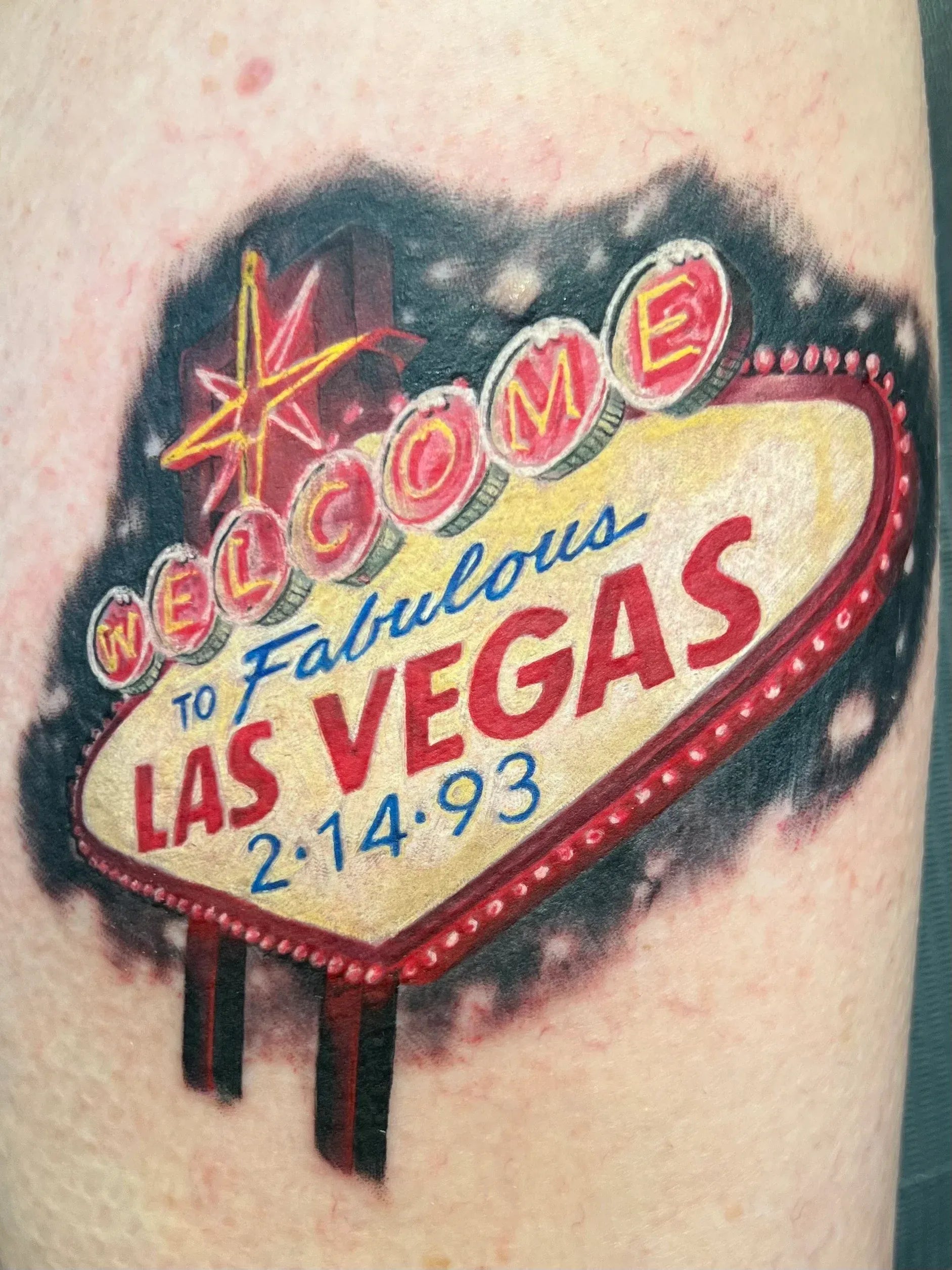 Vibrant color tattoo of the iconic Welcome to Fabulous Las Vegas sign with a custom date.